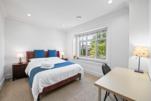 a bedroom with a bed and a desk and a window at 1 Bedroom Luxury Retreat in Prime Vancouver in Vancouver