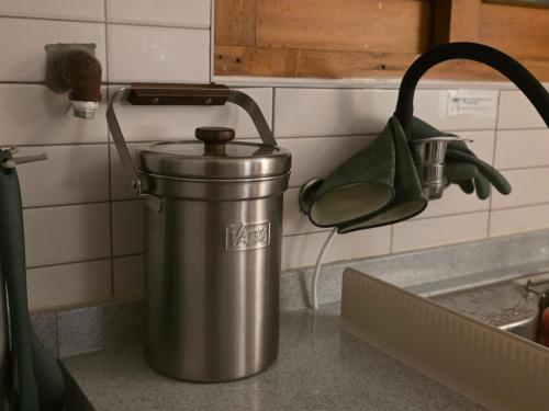 a metal trash can on a counter in a kitchen at Stay EROB in Seoul