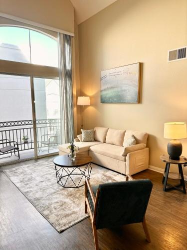 a living room with a couch and a large window at Spacious 2B 2B Pool View Loft Apartment in Marina Del Rey in Los Angeles