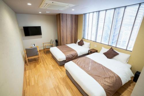 Ένα ή περισσότερα κρεβάτια σε δωμάτιο στο Hotel S-Presso Namba Ekimae