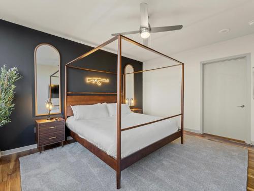 a bedroom with a canopy bed and a ceiling fan at 17th Floor Downtown Dallas Skyline City View High Rise in Dallas