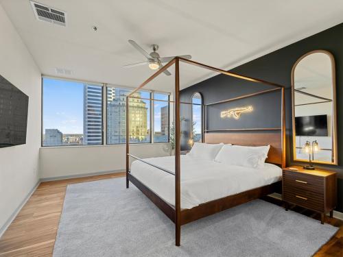 a bedroom with a canopy bed with a view of a city at 17th Floor Downtown Dallas Skyline City View High Rise in Dallas