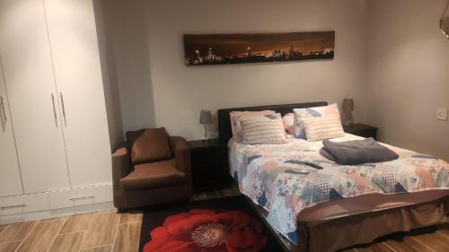 a bedroom with a bed and a chair at Tucked away with a pool view in White River