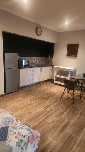 a kitchen with a table and a clock on the wall at Tucked away with a pool view in White River