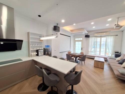 a kitchen and living room with a table and chairs at 宜蘭花境民宿 in Wujie