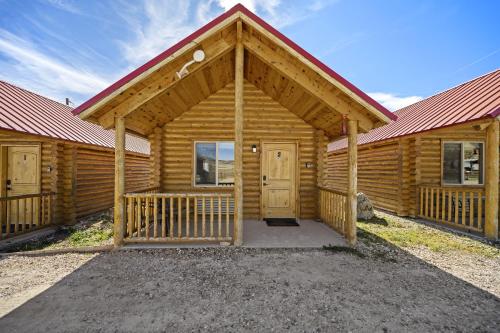 a log cabin with a red roof at Bryce Canyon Log Cabins in Tropic