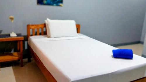a bed with a blue box on top of it at The Nook by GreenPark in Puerto Princesa City