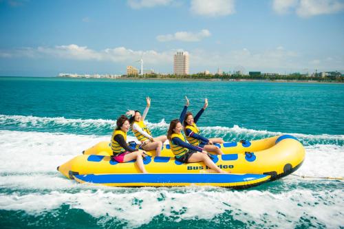 a group of people riding on a raft in the water at El Sol Town Okinawa in Chatan