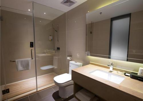 een badkamer met toilet, wastafel en douche bij City Comfort Inn Jiangmen Enping Bus Terminal in Enping