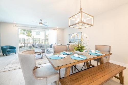 a dining room and living room with a table and chairs at ET013 - Coastal Townhouse with Themed Bedroom at Reunion in Orlando