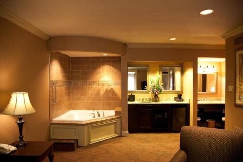 a large bathroom with a tub and a sink at Best Western Plus French Quarter Courtyard Hotel in New Orleans