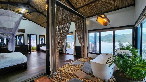 a bedroom with a bed and a room with a view at A Su Homestay Mù Cang Chải in Mù Cang Chải