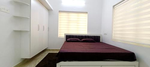 a bedroom with a bed in a room with a window at Heaven Cloud Stay Hub Attappadi in Attappādi