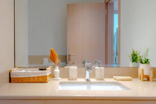 a bathroom with a sink and a mirror at Modern 1-Bed Apartment with Balcony & Free Parking l Near Yas Mall & F1 Yas Island & Sea world in Abu Dhabi