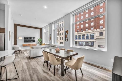 a living room with a table and chairs and a couch at Luxe Flat with Heated Pool Sauna Rooftop Deck Gym in Cleveland