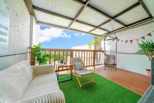 a balcony with a hammock and a chair on a deck at 木Box田妍山色 in Jiaoxi