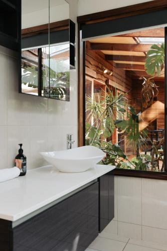 a bathroom with a sink and a large window at Bimbi Forest Eco Lodge - Denmark in Denmark