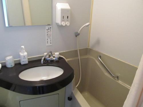 a bathroom with a sink and a shower at Hotel Cerezo in Tokyo