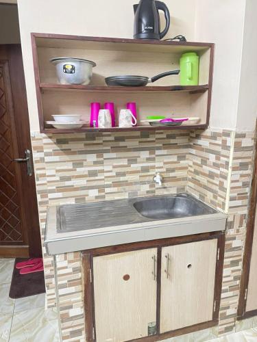 a kitchen with a sink and a counter top at Danfo in Mto Panga