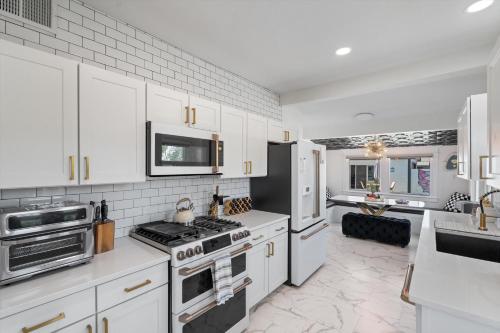 a kitchen with white cabinets and a stove top oven at Casa Lumina in Phoenix