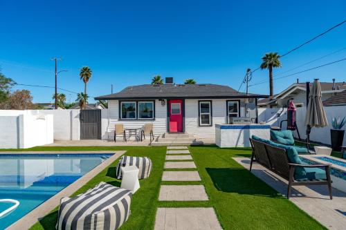 a backyard with a pool and a house at Casa Lumina in Phoenix
