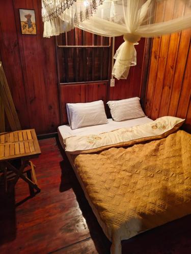 a bedroom with two beds and a chandelier at Nùng An homestay-Nùng ethnic group in Bà Dương