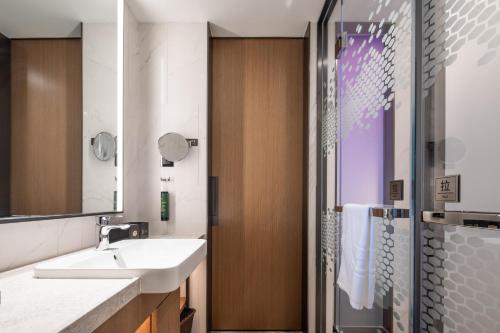 een badkamer met wastafel en douche bij Hilton Garden Inn Chengde Mountain Resort in Niuquanzigou