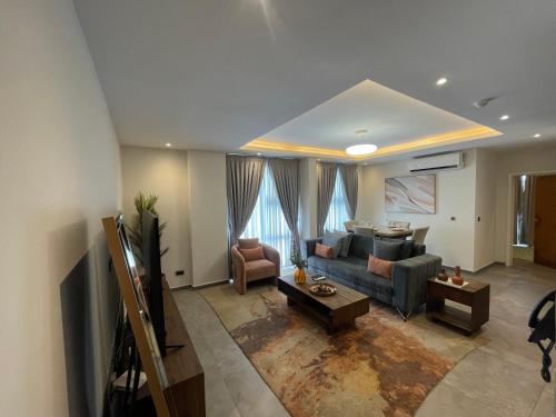 a living room with a couch and a table at Cantonments One Bedroom Deluxe in Accra