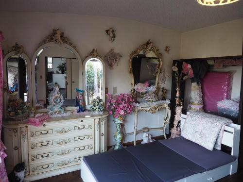 a bedroom with a dresser and a bed and mirrors at HealingDragon 　Sunrise house Shirahama in Shimoda