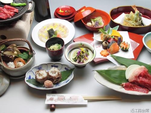 a table topped with plates of food on a table at Hikone Station Hotel in Hikone