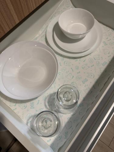 two plates and bowls sitting on a table at Maple Grove Yasuragi Stay in General Trias