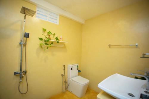 a bathroom with a shower and a toilet and a sink at Villa Amor by the Beach in Ambalangoda