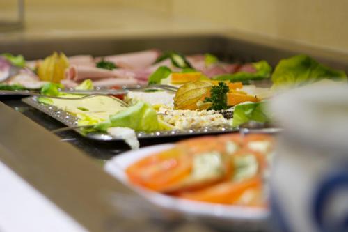 a plate of food on a table with vegetables at City Hotel Hannover in Hannover