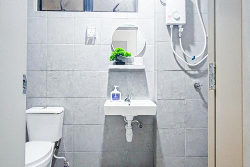 a bathroom with a toilet and a sink and a shower at Balcony Breeze at Ara Residence Nilai by HCK in Nilai