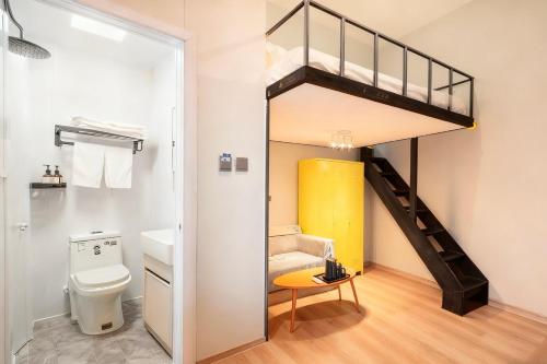 a bathroom with a loft bed and a toilet at Beijing Liangcang Hotel 10-minute walk to Tiananmen Square and the Forbidden City Free registration service for Tiananmen access 200 meters from the subway Beijing Cultural Hub Free coffee & free laundry service in Beijing