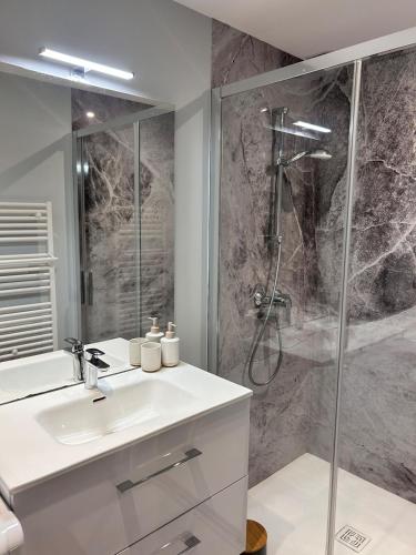 a bathroom with a sink and a shower at Le scandinave in Pont-de-Veyle