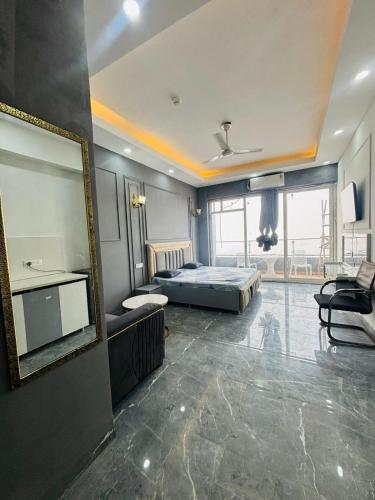 a bedroom with a bed and a large mirror at Moonrisehomestays in Ghaziabad