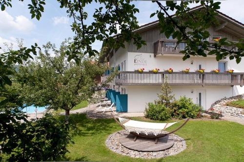 a house with a hammock in front of it at Hotel-Gasthof Zur Linde in Neukirchen beim Heiligen Blut