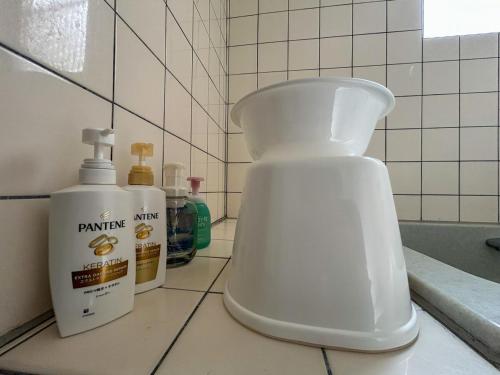 a bottle of cleaning agent sitting on a bathroom counter at 2nd Home Kaminagayoshi in Ichihara