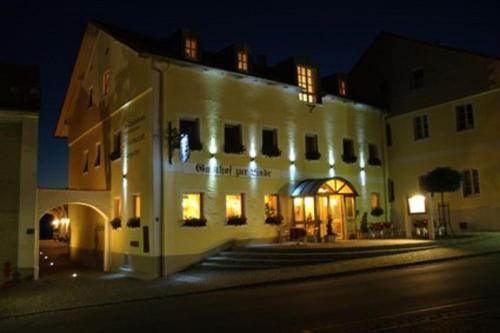 a large white building with lights on it at night at Hotel-Gasthof Zur Linde in Neukirchen beim Heiligen Blut