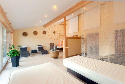 a living room with a couch and a table at Hotel-Gasthof Zur Linde in Neukirchen beim Heiligen Blut