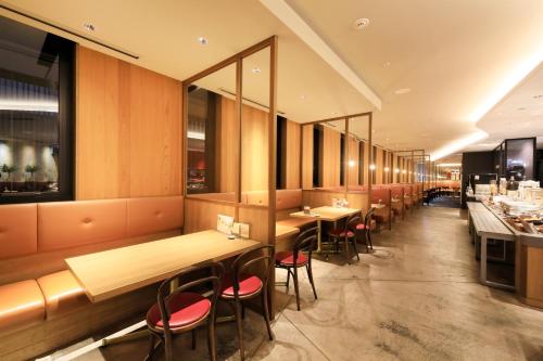 a row of tables and chairs in a restaurant at Richmond Hotel Tenjin Nishi-Dori in Fukuoka