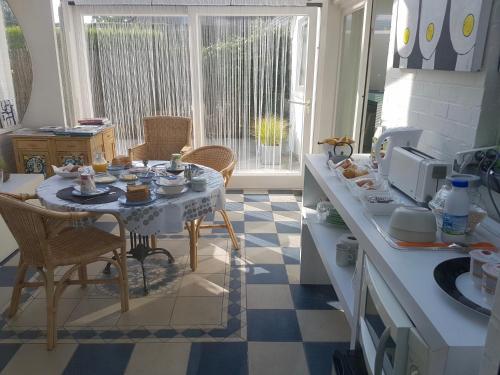 a kitchen with a table with food on it at Art-hill in Jabbeke
