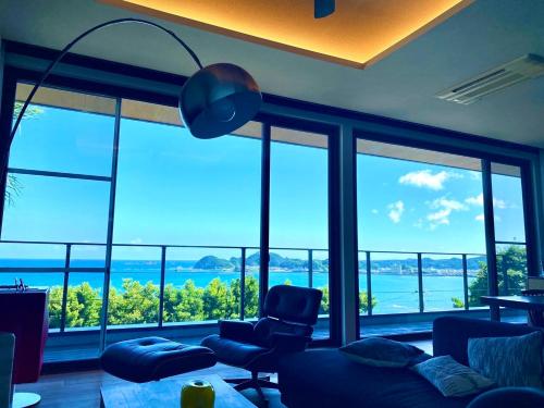 a living room with a view of the ocean at The House of Ocean in Nachikatsuura