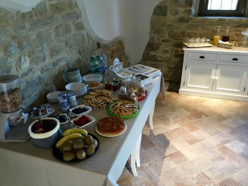 a table with many different types of food on it at Agriturismo Fonte Rosa in Fiastra