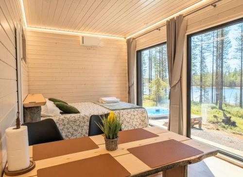 a small room with a bed and a table with chairs at Spa Cabin by Hossaville in Hossa