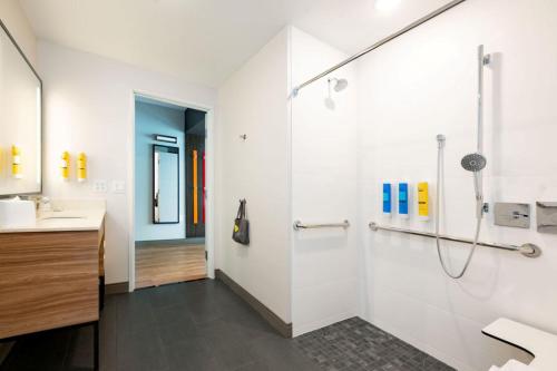 a bathroom with a shower and a sink at Tru By Hilton Grimes Des Moines in Grimes