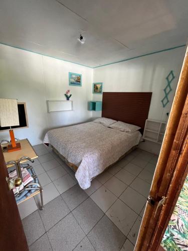 a bedroom with a large bed and a table at Ancoa Lodge in Linares