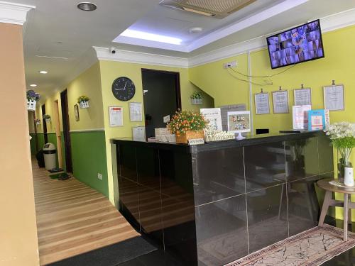 a room with a counter and a clock on the wall at Five Ferns Hotel in Bandar Baru Bangi