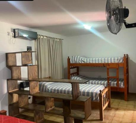 a room with two bunk beds and a fan at Alojamientos en Cosquín in Cosquín